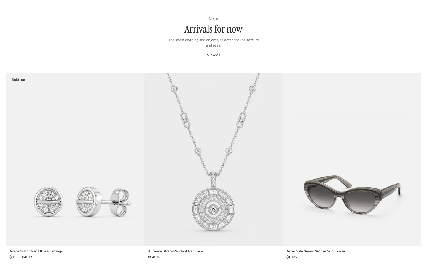Featured products with a centered heading Arrivals for now, a View all link, and three large product cards in a row.
